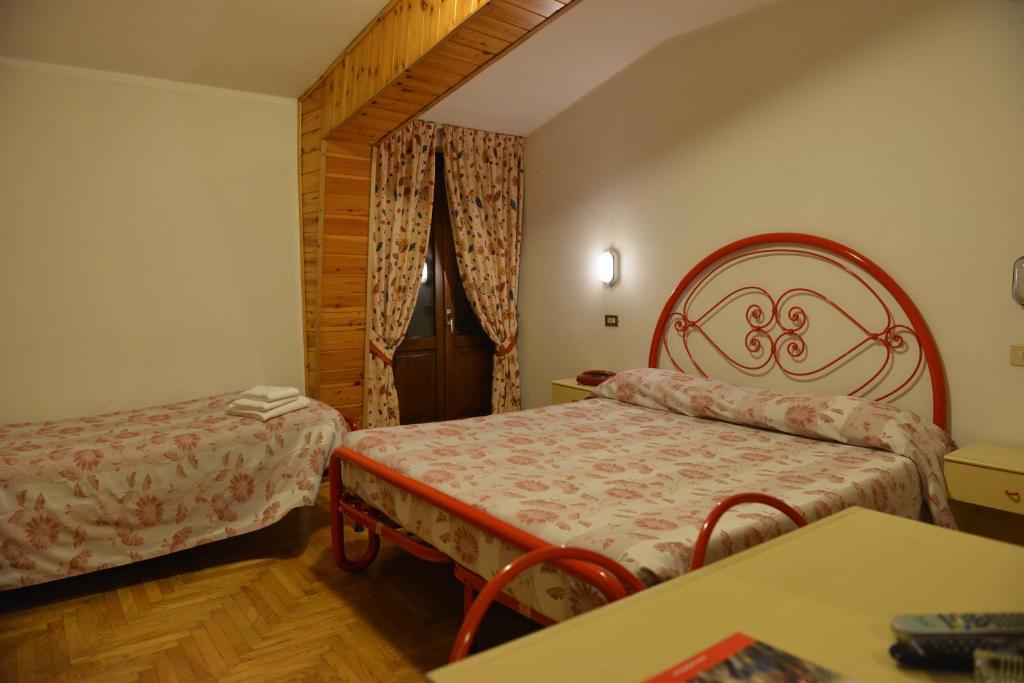 Posteľ alebo postele v izbe v ubytovaní Hotel Gufo