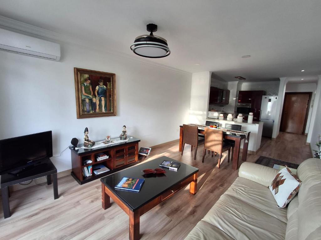 a living room with a couch and a table at Apartamento frente a la playa Piso 2 in Estepona