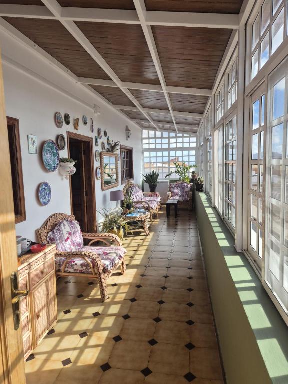a living room with couches and windows at Los Molinos in Valles de Ortega