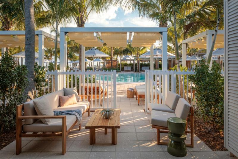 a patio with chairs and a table and a pool at Islander Resort in Islamorada