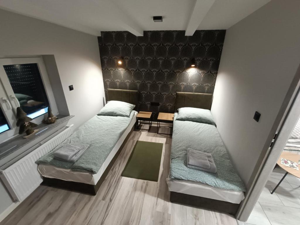 Ένα ή περισσότερα κρεβάτια σε δωμάτιο στο Apartamenty na Tylnej w Śremie