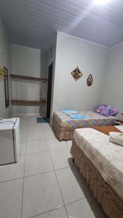 Cama ou camas em um quarto em Pousada Giro das dunas