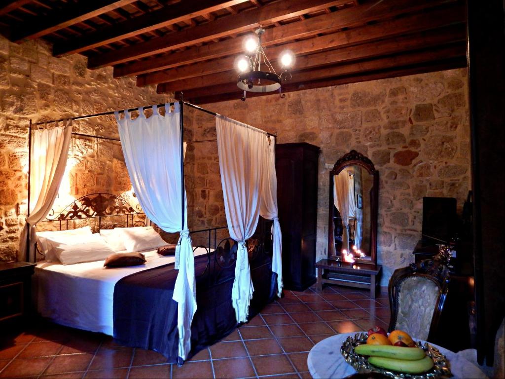 A bed or beds in a room at S.Nikolis' Historic Boutique Hotel