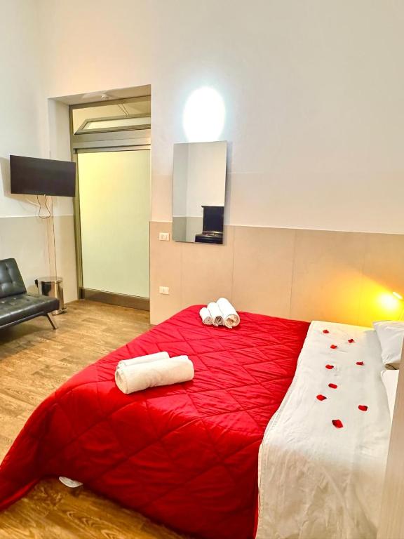 a large red bed with two towels on it at marsala centro storico in Marsala