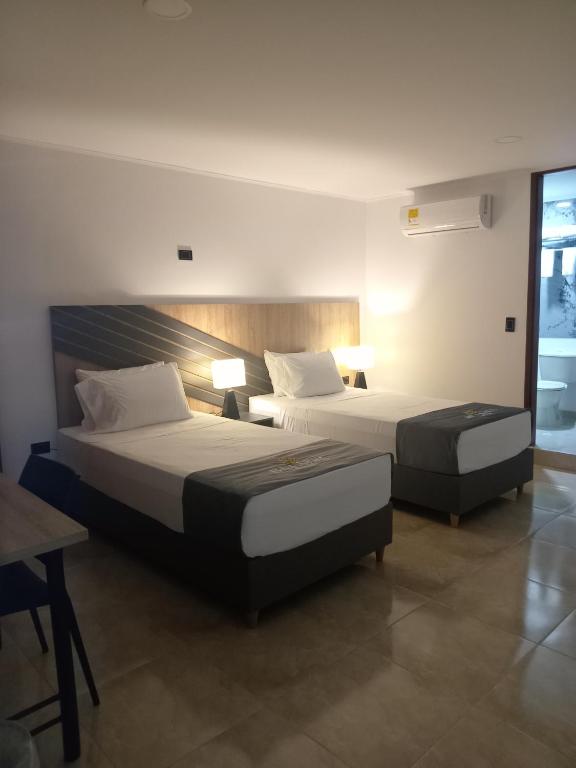 Postel nebo postele na pokoji v ubytování Buendía Hotel