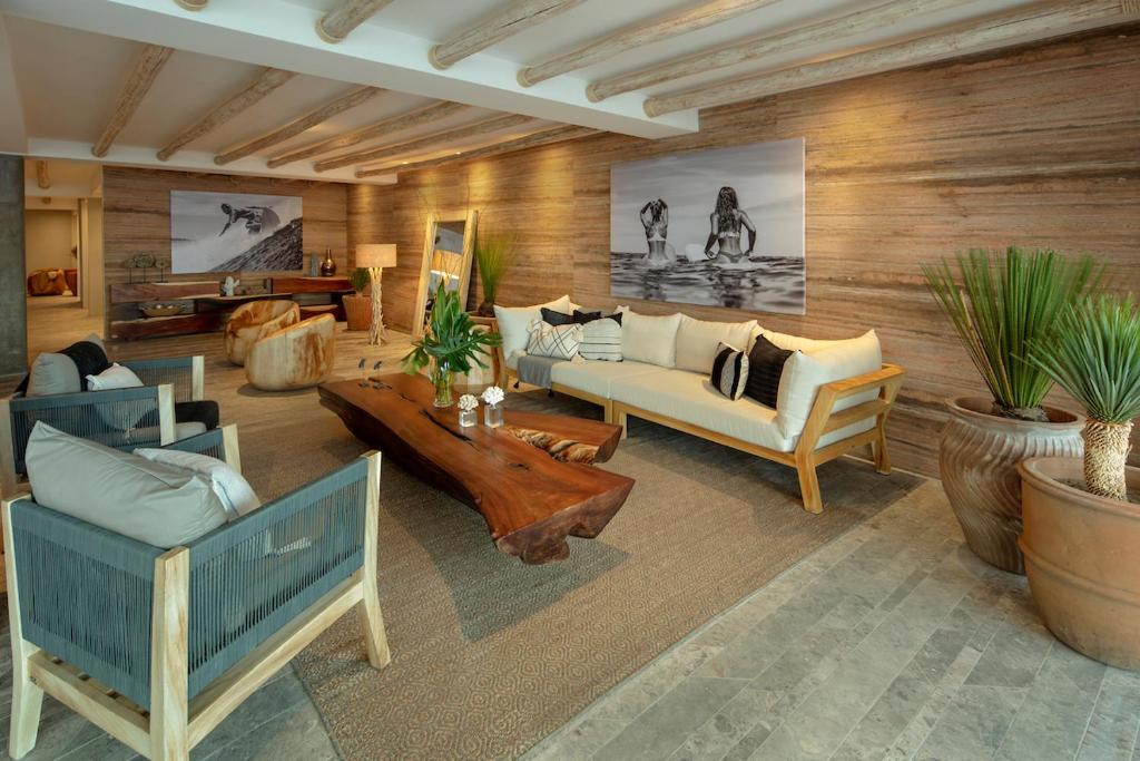 a living room with a couch and a table at Oceanfront Living & Surfing in Cabo Paradisiacal 2BR Condo in San José del Cabo