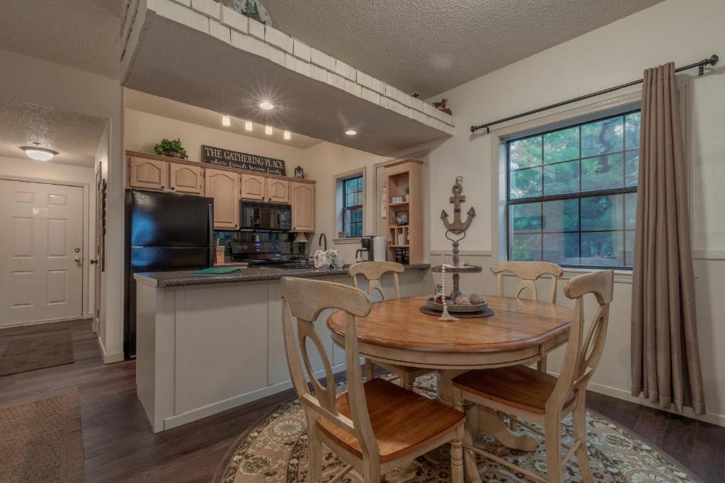 a kitchen with a wooden table and chairs in a room at 2BR Village At Indian Point 705 near SDC-Free Tickets Daily up to $500 Value in Branson