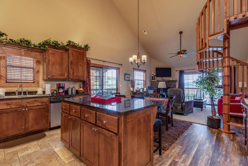 a kitchen with wooden cabinets and a living room at 2BR+Loft Village At Indian Point 1509 near SDC- Free Tickets Daily up to $500 in Branson