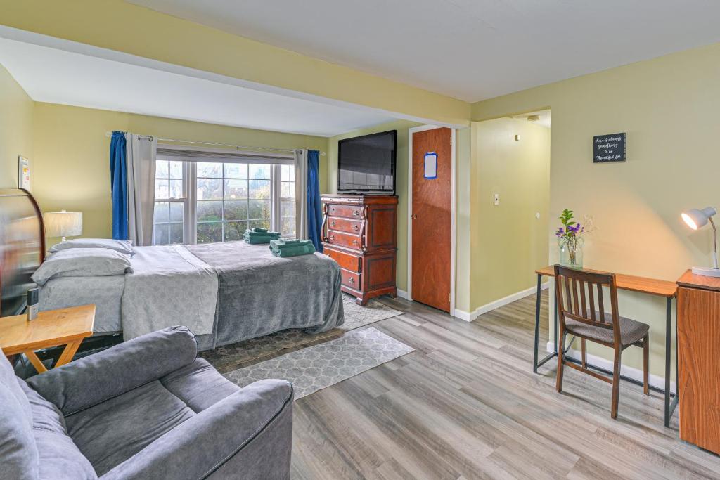a living room with a bed and a couch at 2 Mi to UBS Arena WFH-Friendly Couples Retreat in South Floral Park