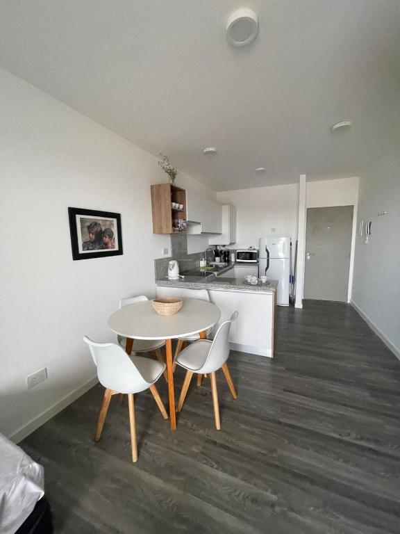 a kitchen with a table and chairs in a room at Roma in Belén de Escobar