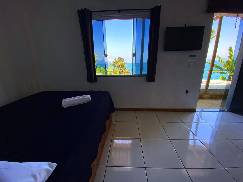 Ένα ή περισσότερα κρεβάτια σε δωμάτιο στο SUÍTES BEIRA-MAR Angra