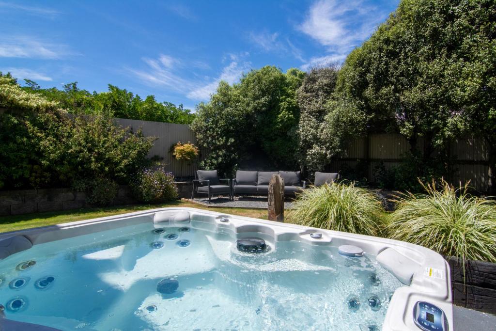 a hot tub in a yard with a patio at Close to Beach, Spacious, Outdoor Living - KK00379 in Kaikoura