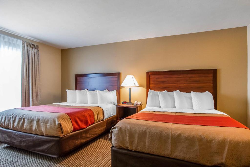 a hotel room with two beds and a window at MainStay Suites Grand Island in Grand Island