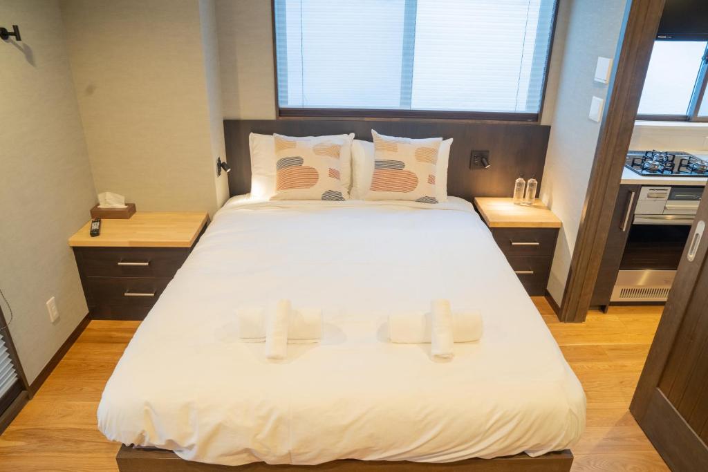 Postel nebo postele na pokoji v ubytování T Square Hakuba