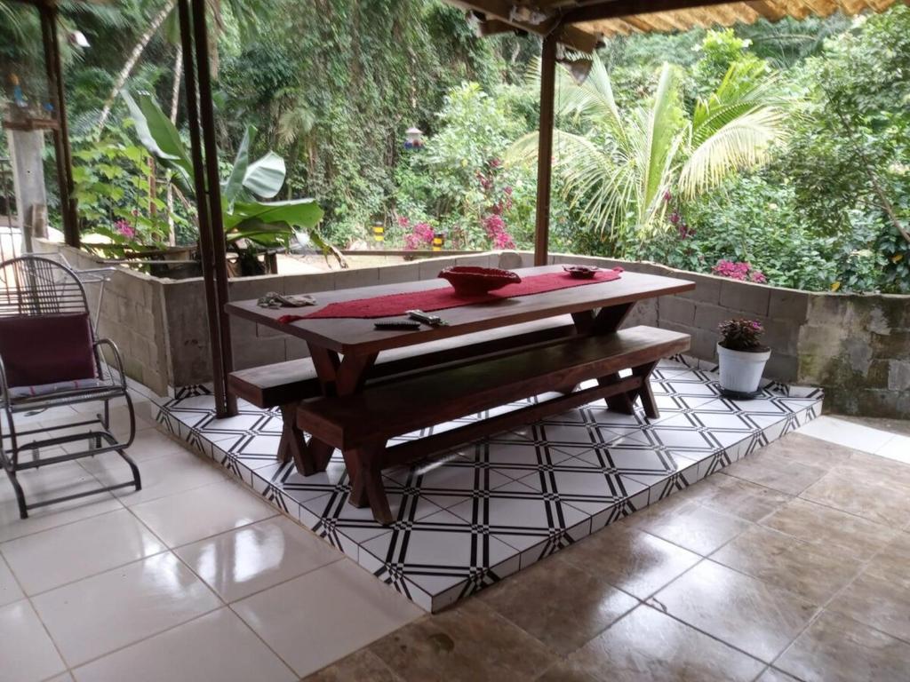 a ping pong table and a chair on a patio at Casa da Mata in Ubatuba