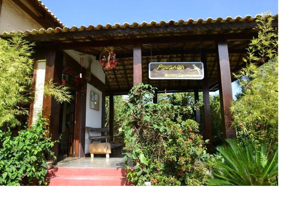 a house with a sign on the front of it at Pousada Morro Encantado in Cavalcante