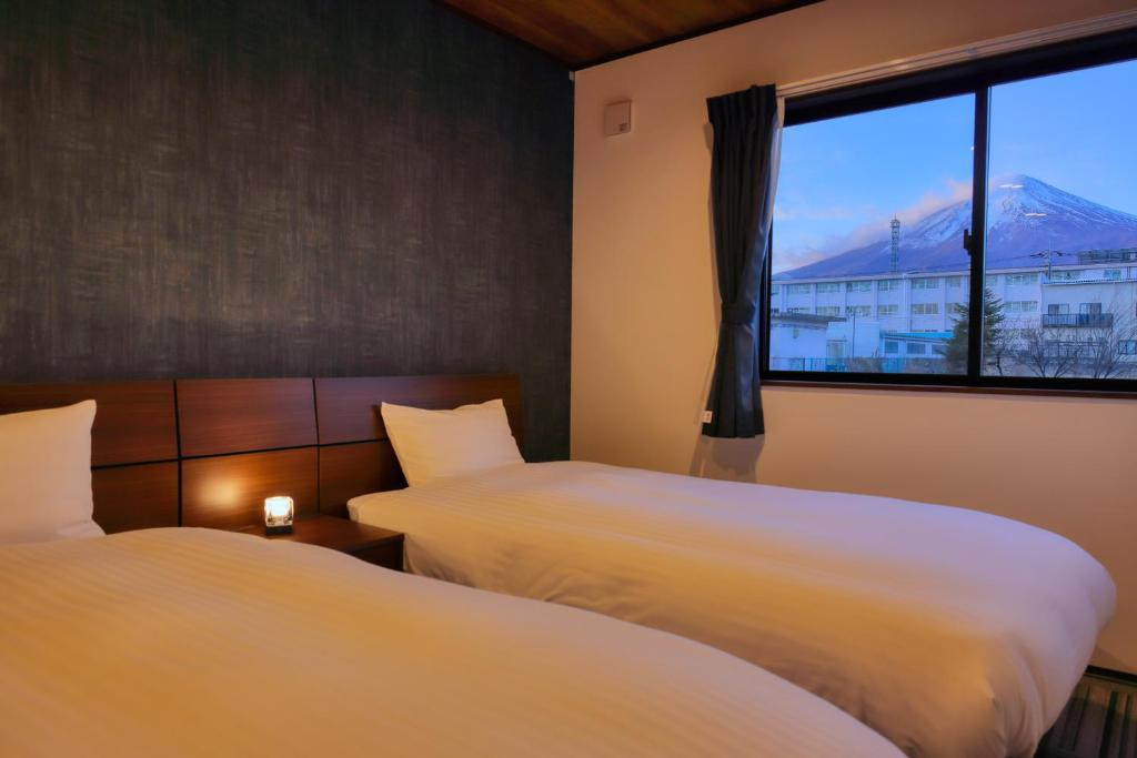 Postel nebo postele na pokoji v ubytování Villas Fuji Sengen ヴィラス富士浅間