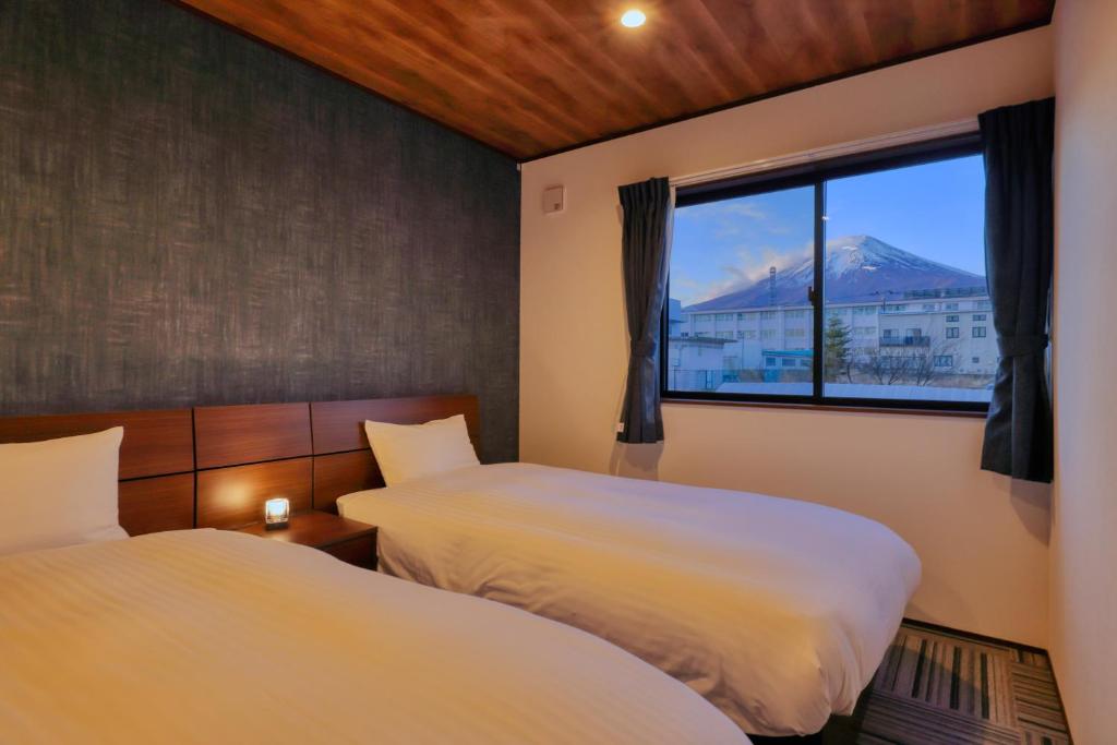 Postel nebo postele na pokoji v ubytování Villas Fuji Sengen ヴィラス富士浅間