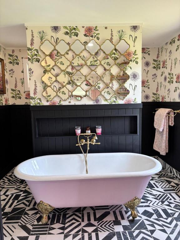 a bath tub in a bathroom with a wall at Lenlie Farm in Howard