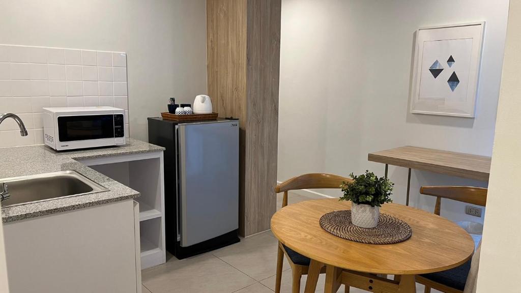 A compact kitchenette and dining nook with a round table for two.