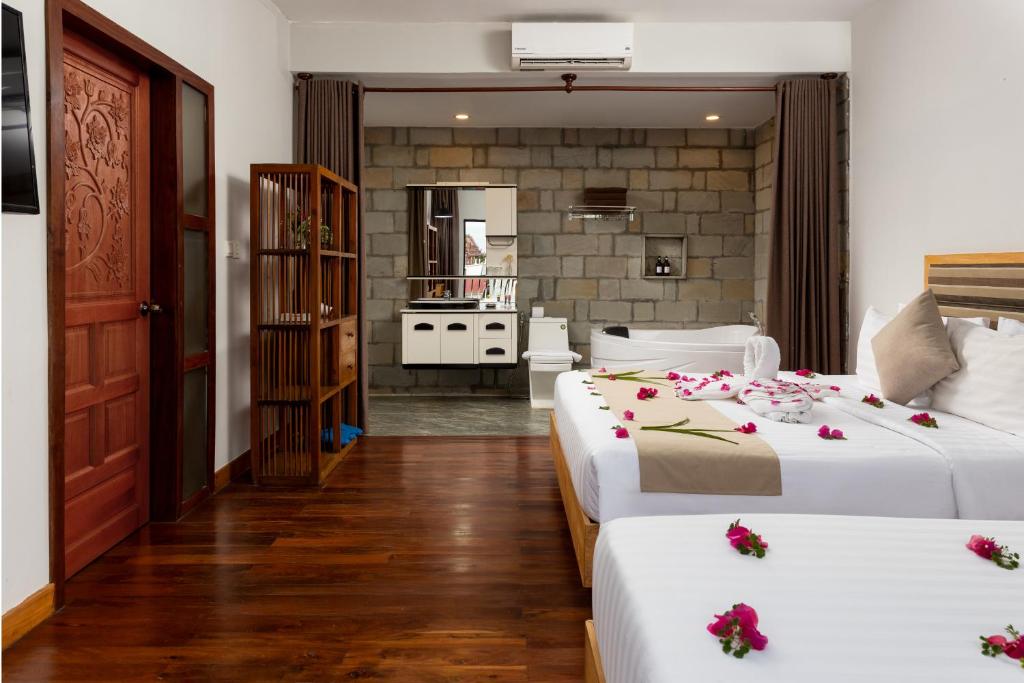 Postel nebo postele na pokoji v ubytování SIEM REAP RIVER VIEW Residence