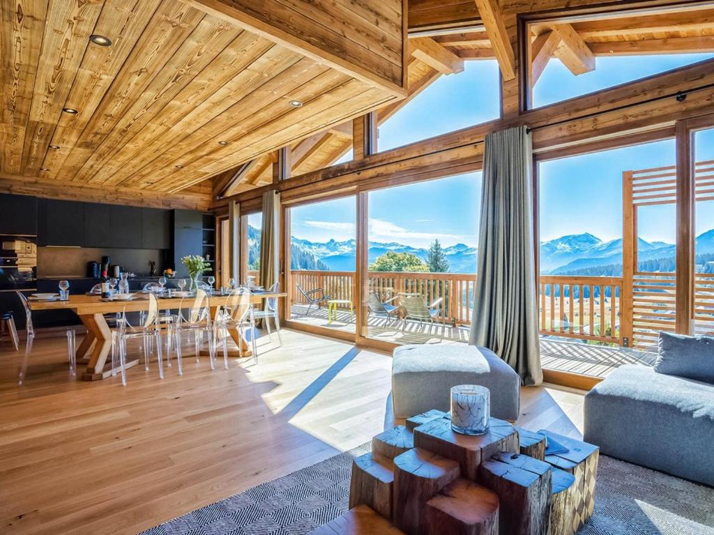 a living room with a view of the mountains at Chalet luxueux avec jacuzzi, 7 pièces, proche pistes, pour 15 pers. - FR-1-810-28 in Hauteluce
