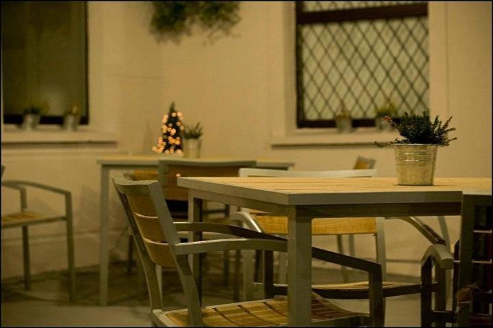 a table and chairs with a christmas tree in a room at Hatton's of Garadice in Garadice