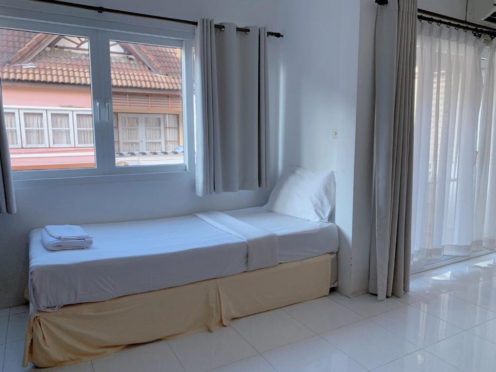 Postel nebo postele na pokoji v ubytování Sunshine Guest House