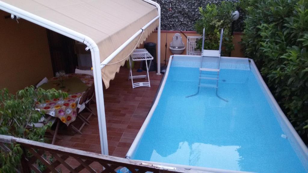 a swimming pool with a canopy and a swimming pool at Holiday Home Villa Relax in Palermo