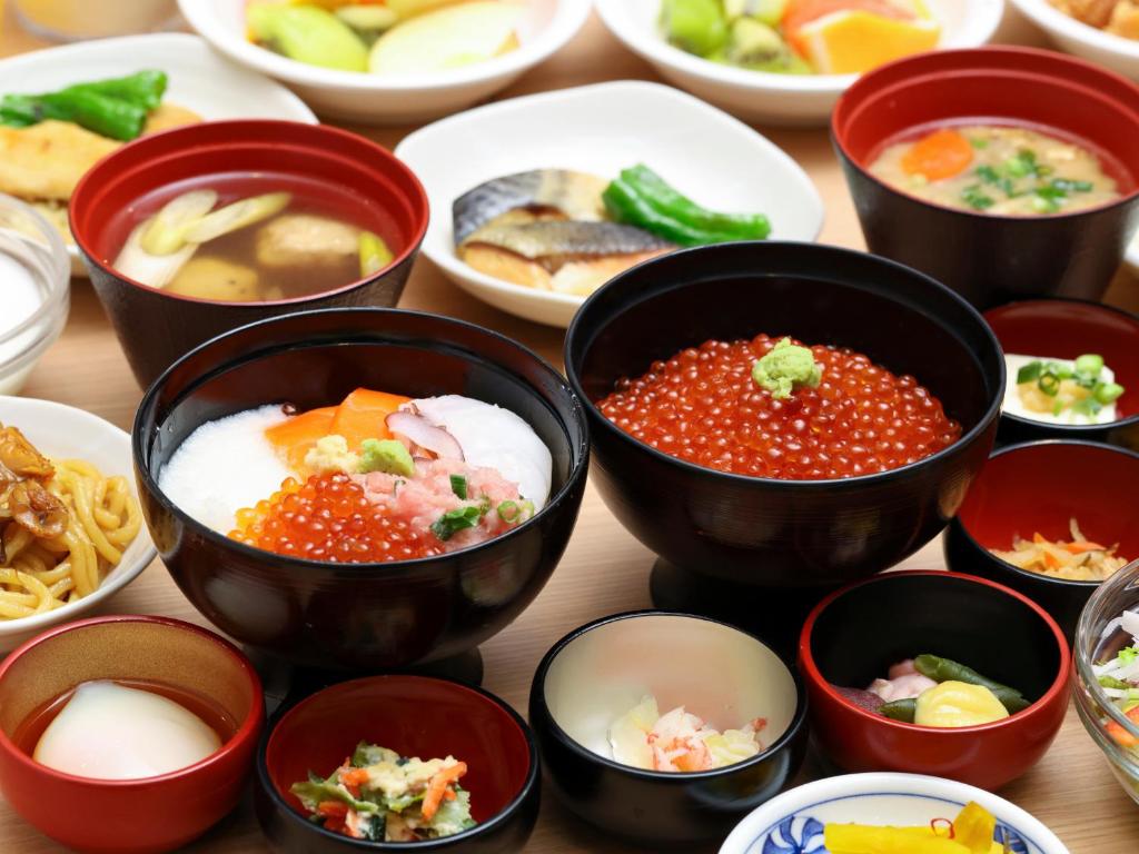 a group of bowls of food on a table at Dormy Inn Wakkanai in Wakkanai