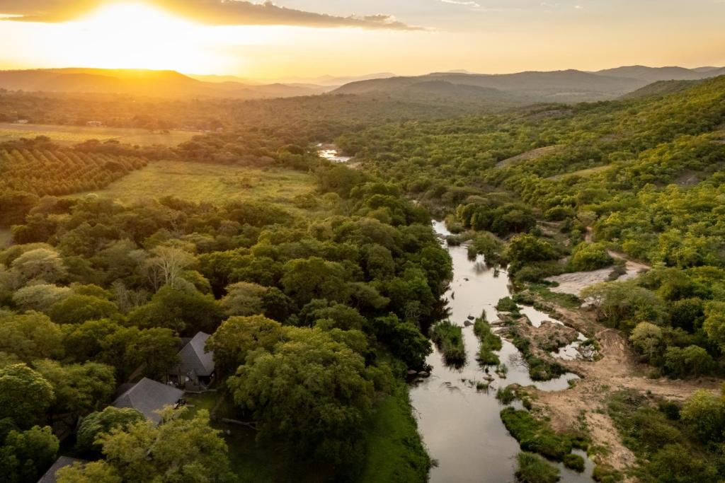 an aerial view of a river with trees at First Group Sanbonani Resort in Hazyview