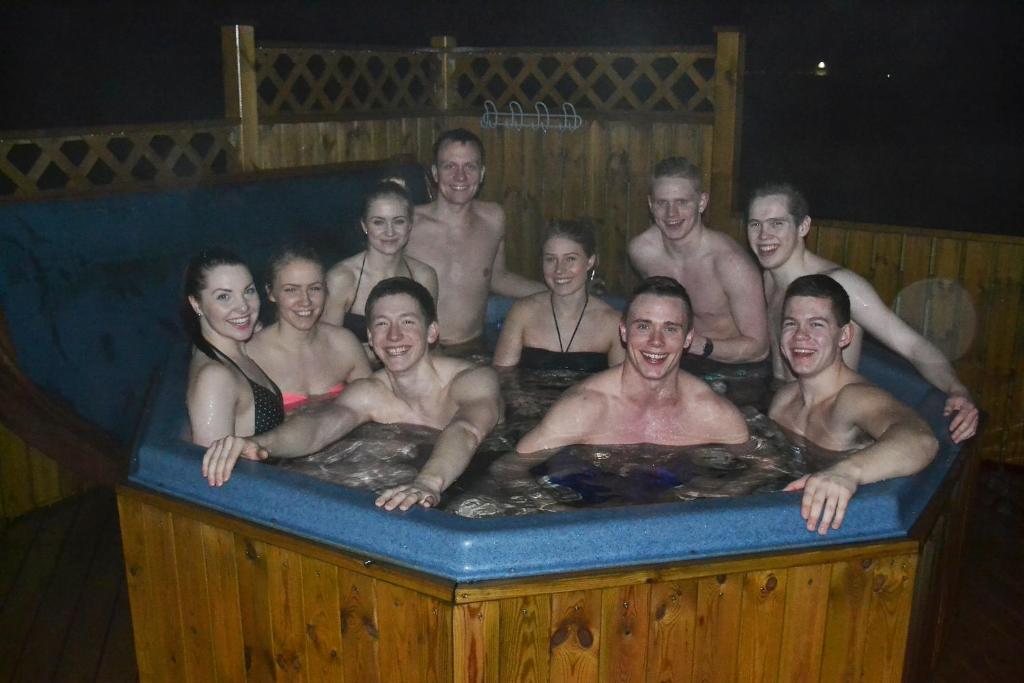 a group of people in a bath tub at Lambastadir Guesthouse in Selfoss