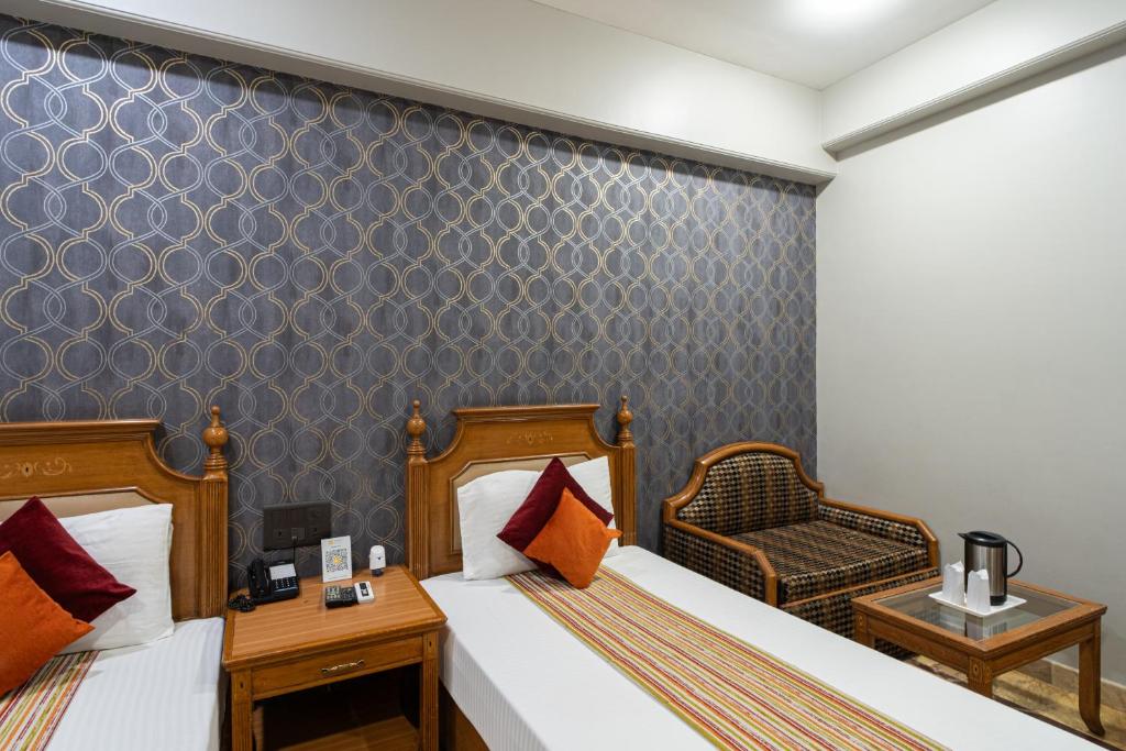 Postel nebo postele na pokoji v ubytování Hotel Sunstar Grand