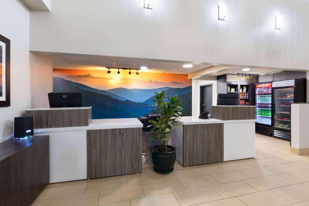 a hotel lobby with a mountain mural on the wall at La Quinta by Wyndham Sevierville / Kodak in Sevierville