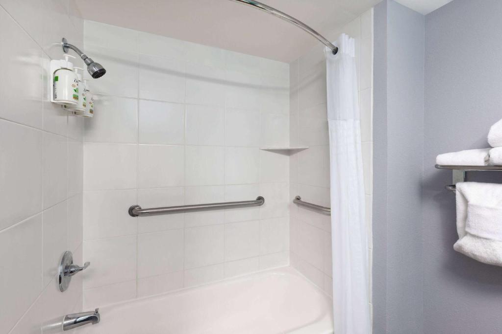 a bathroom with a shower with a tub and a toilet at La Quinta by Wyndham Sevierville / Kodak in Sevierville