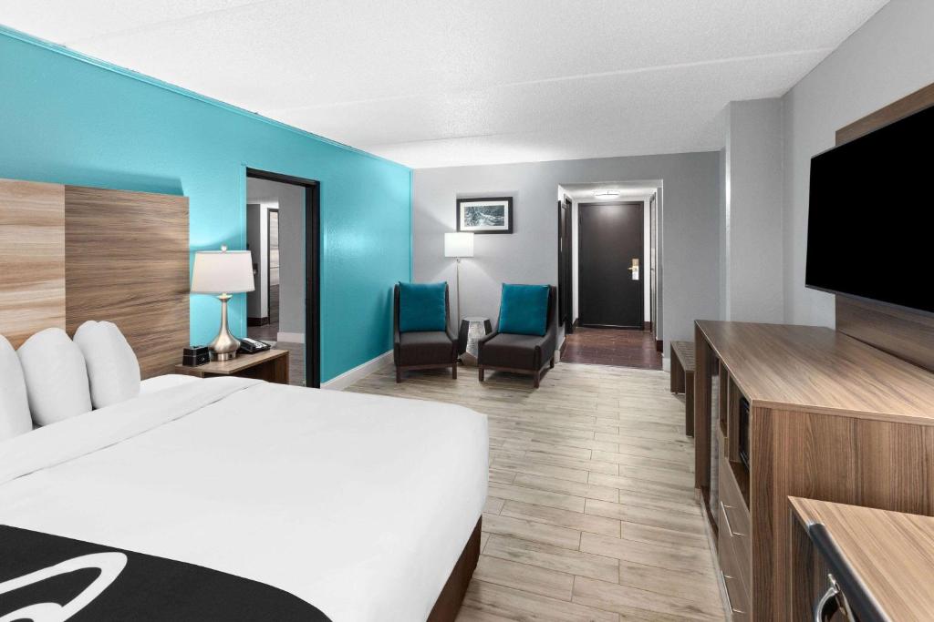 a hotel room with a bed and a flat screen tv at La Quinta by Wyndham Sevierville / Kodak in Sevierville