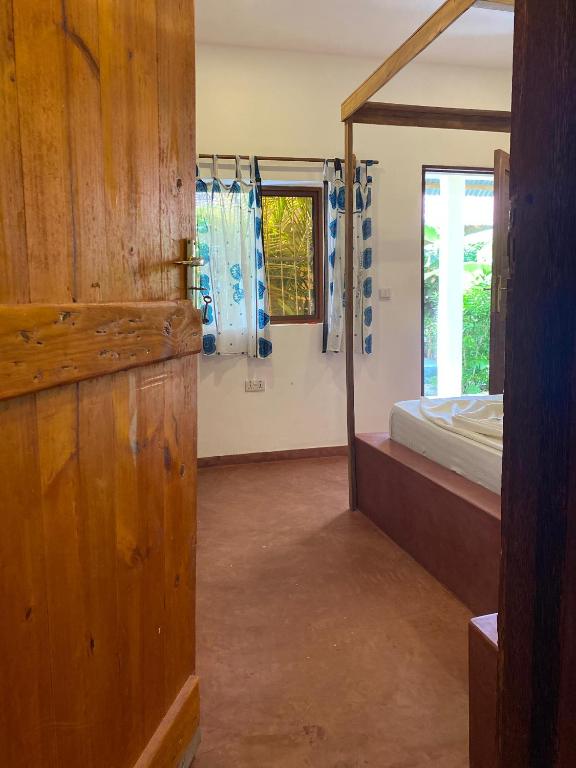 Postel nebo postele na pokoji v ubytování Shamba Village