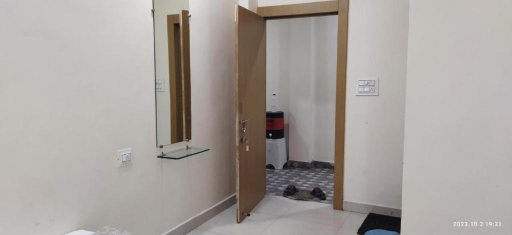 an empty hallway with a door and a mirror at Gajlaxmi HOTEL UJJAIN in Ujjain