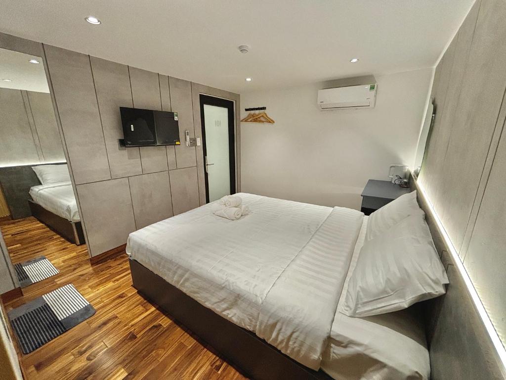 Postel nebo postele na pokoji v ubytování CEVA Hotel & Apartment Danang