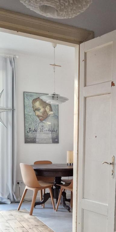 a dining room with a table and a piano at Hillside view house with garden, private parking, quiet location - 12 min to Old town anytime, Long stays welcome in Vilnius