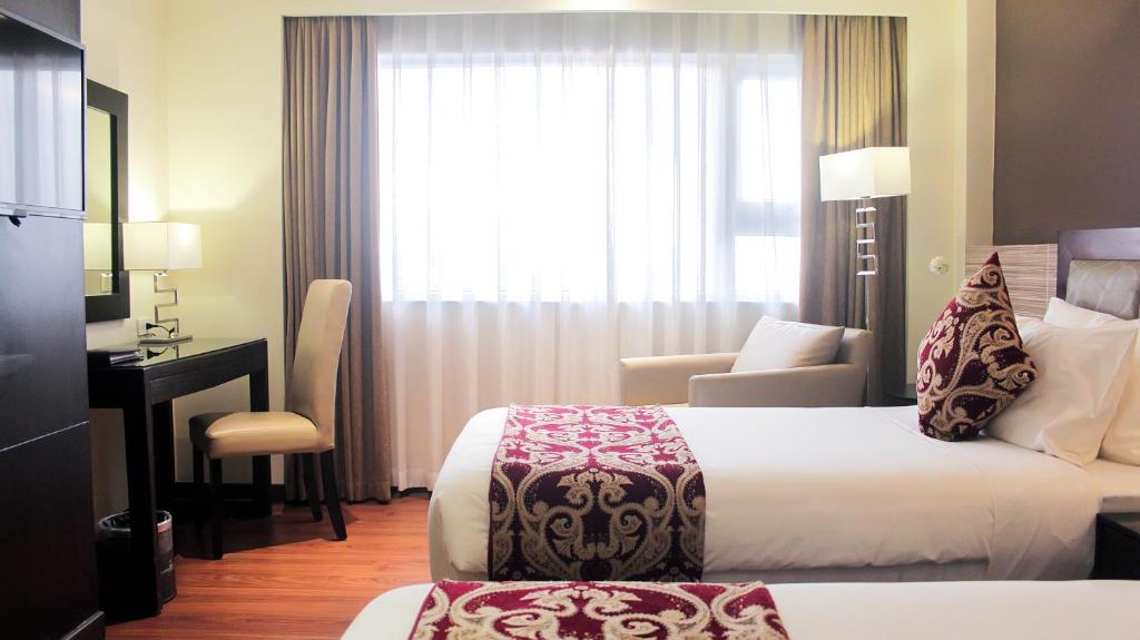 Postel nebo postele na pokoji v ubytování Brentwood Suites