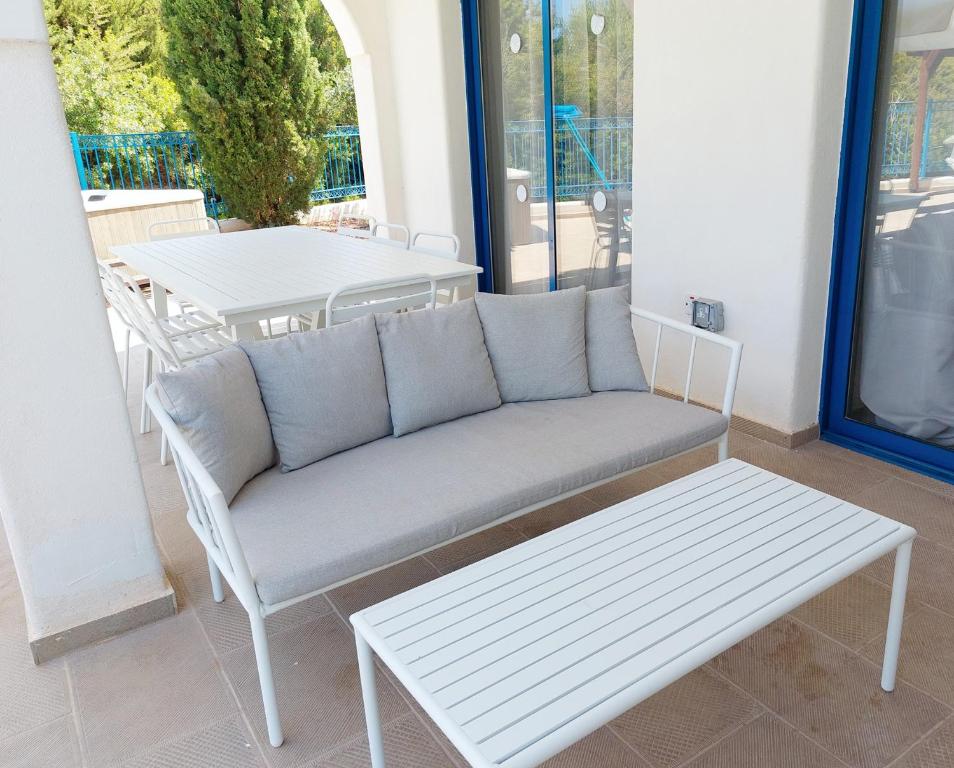 a couch and a table on a patio at Azzurro Holiday Villas in Peyia