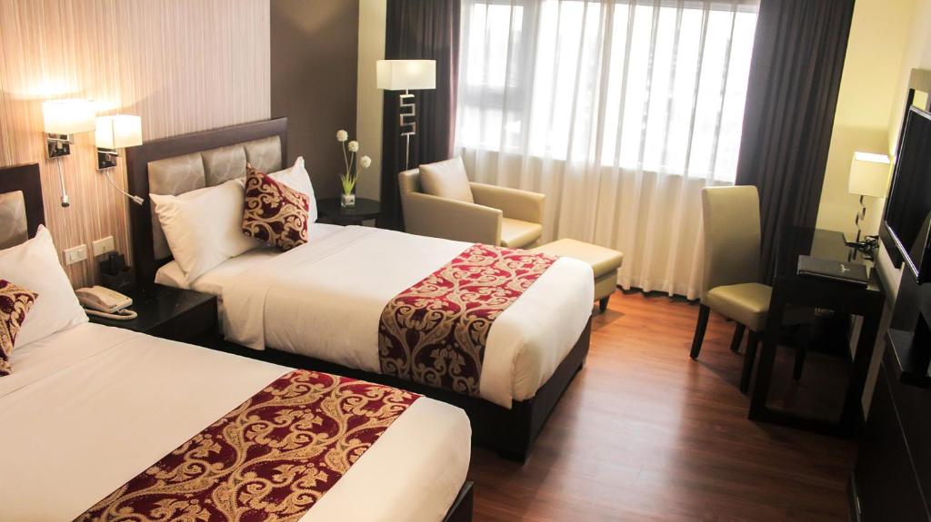 Postel nebo postele na pokoji v ubytování Brentwood Suites
