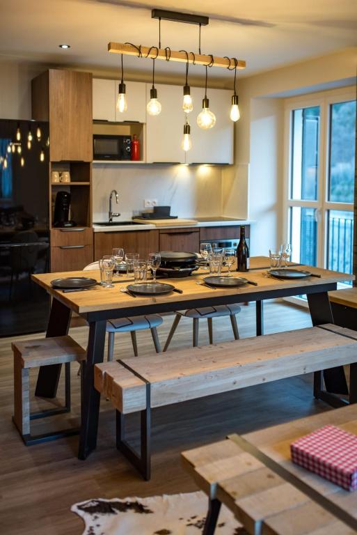 une cuisine avec une grande table en bois et des bancs dans l'établissement 4-6 people in Orelle quick access to Val Thorens, à Orelle