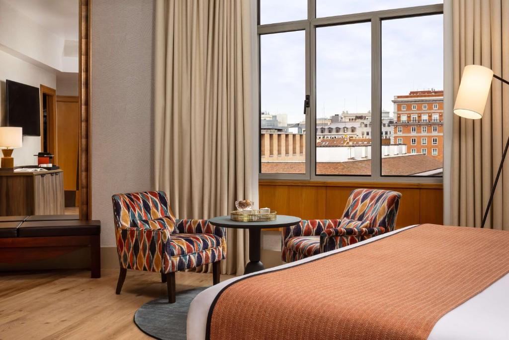 A bed or beds in a room at NH Collection Madrid Paseo del Prado