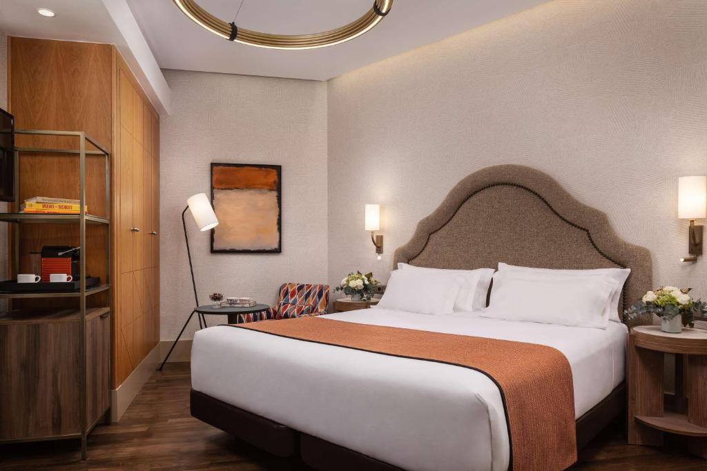 A bed or beds in a room at NH Collection Madrid Paseo del Prado