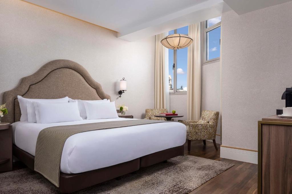 A bed or beds in a room at NH Collection Madrid Paseo del Prado
