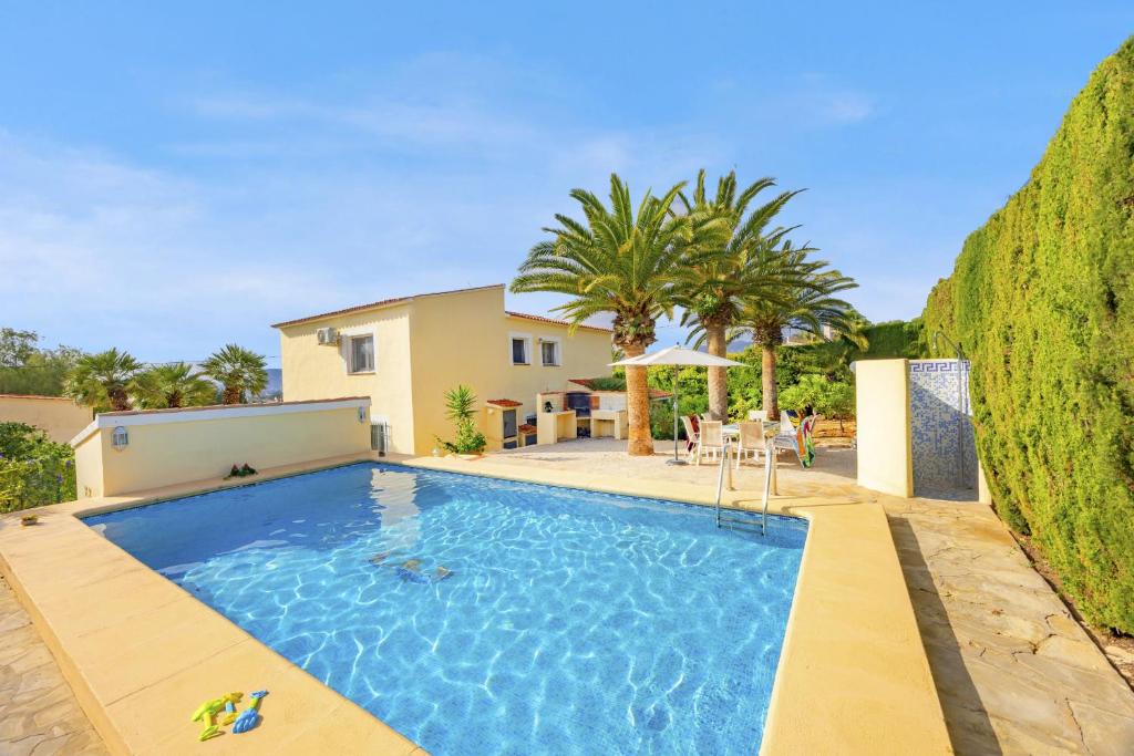 a swimming pool in the backyard of a house at Villa Carola - PlusHolidays in Ifach