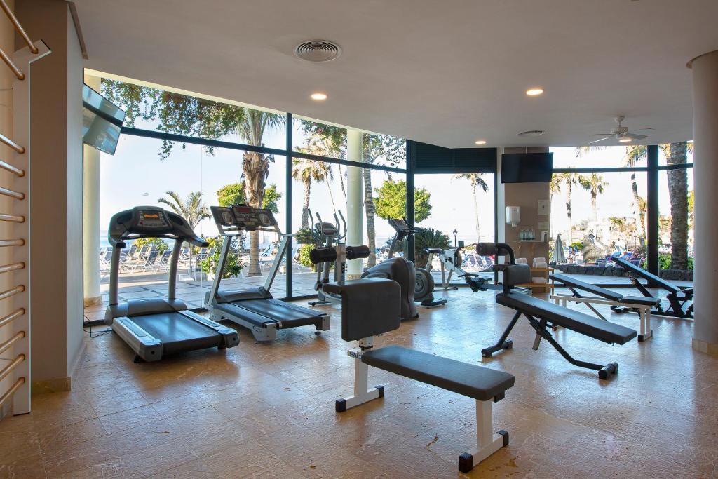 a gym with a bunch of treadmills and machines at Hipotels Natura Palace Adults Only in Playa Blanca
