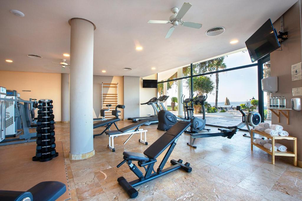 a gym with several treadmills and elliptical machines at Hipotels Natura Palace Adults Only in Playa Blanca